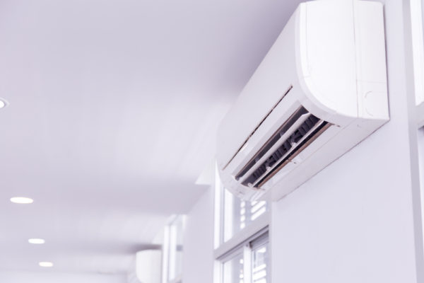 Man changes the filter in the air conditioner.