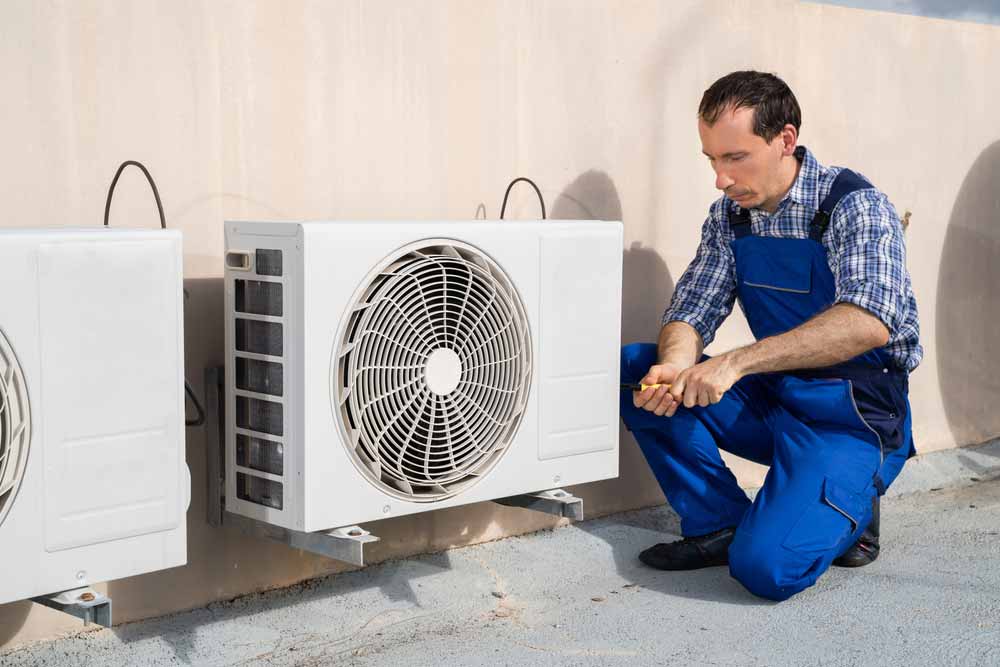 Technician Repairing Air Conditioning System